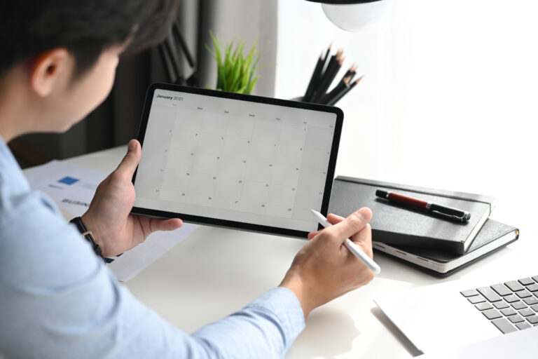 businessman-is-looking-calendar-with-daily-agenda-tablet Online planning maken invullen op tablet symagic